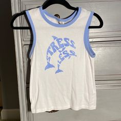 Fits Like A Medium, Urban Outfitters Tank Top, Stress Less With Dolphins, Never Worn Urban Outfitters Sleeveless Cotton Top, Urban Outfitters Blue Tops With Graphic Print, Urban Outfitters Blue Graphic Print Tops, Urban Outfitters Graphic Print Summer Top, Urban Outfitters Crew Neck Tops For Summer, White Letter Print Top From Urban Outfitters, Urban Outfitters Letter Print Tops For Spring, Urban Outfitters Tank Top, Urban Outfitters Tops