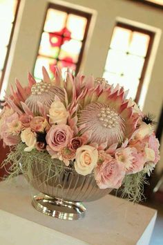 a vase filled with pink flowers on top of a table