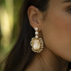 * PRE-ORDER items take 4-5 weeks to ship. Please be aware of this before purchasing. The Amelia dangle pearl earrings are the perfect statement to bring out your feminine, romantic side. Featuring 22ct gold-plated brass, freshwater baroque pearls, and acrylic pearls. Handmade by artisans in India. Limited quantity available. For pierced ears22ct gold plated brassCream baroque pearlsAcrylic pearls Size & Fit L: 2 2/4" longW: 1" wideWeight: 13g Please note slight natural variances may occur betwee Classy Statement Earrings, Boho Bridal Earrings Gold, Chunky Pearl Earrings, Statement Pearl Earrings, Statement Wedding Earrings, Bride Earrings Pearl, Statement Bridal Earrings, Unique Wedding Earrings, Bridal Earrings Gold