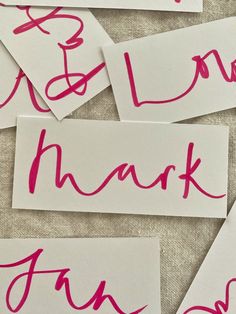 several pieces of paper with writing on them that say thank and one has pink ink