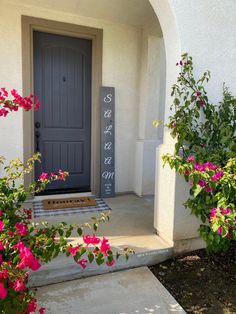 the front door is decorated with pink flowers