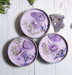 three small bowls filled with different types of purple stuff on top of a white table