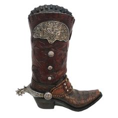 Add a playful, stylish, and truly Western detail to any room with this Tooled Cowboy Boot Vase. This vase is crafted from durable resin and made to look like an actual cowboy boot, complete with tooled leather detailing, silver metal accents, and spurs. Complement with other home accessories from our range of Western and Southwestern collections for a coordinated home look. Paseo Road by HiEnd Accents | Paseo Road by HiEnd Accents 12" Resin Cowboy Boot Vase 12.0 H x 9.0 W x 3.0 D in Resin / Plas Cowboy Boot Vase, Turquoise Cowboy Boots, Boot Vase, Brown Cowgirl Boots, Western Brown, Dr Shoes, Floral Heels, Metal Accents, Cow Boy