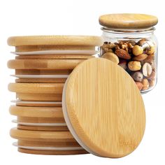 a jar filled with nuts next to stacks of wooden plates