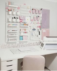 a white desk topped with a computer and lots of shelves filled with crafting supplies