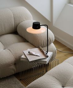 a lamp sitting on top of a table next to a couch