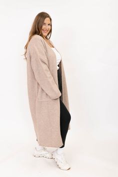 A long cozy cardigan is a staple in Jill's fall wardrobe! The JH x S+T Sweater Weather Long Cardigan is versatile, stylish, and makes you feel like you're wrapped up in a cozy blanket. Throw it over your fave Romper, go-to leggings or even a cute fall dress. This cardi will take you from daycare drop off all the way to date night, keeping you comfy all day long. This feathery soft knit yarn that keeps you warm without any itchiness, with pockets (of course) and a maxi length that adds an elevated touch. Long cardigan in our favourite soft and feathery sweater yarn Clean neckline with dropped shoulders and long sleeves 2 front patch pockets Rolled edge hem Long length - intended to hit between below the knee to low calf Front body length - 47" based on size M/L 5 Group sizing: 3XS/2XS, XS/S Cute Fall Dress, Fall Dress, Cozy Cardigan, Drop Off, Maternity Shops, Blanket Throw, Romper Dress, Fabric Shop, Top Sales