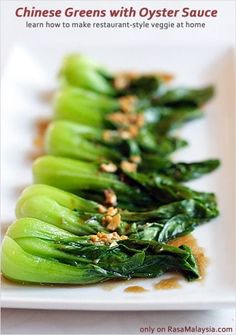 chinese greens with oyster sauce on a white plate