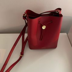 Lauren Ralph Lauren Drawstring Bucket Bag Color: Red Condition: Brand New Luxury Bucket Bag With Adjustable Strap As Gift, Red Bucket Shoulder Bag As Gift, Red Evening Bucket Bag With Dust Bag Included, Bucket Bag With Detachable Strap As Gift, Red Bucket Bag For Evening With Dust Bag, Red Bucket Shoulder Bag For Gift, Designer Red Bucket Bag For Formal Occasions, Gift Shoulder Bag With Gold-tone Hardware, Red Bucket Bag For Evening