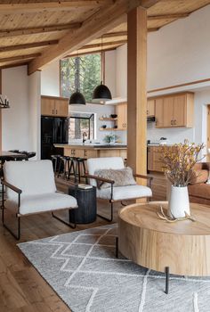 a living room filled with furniture next to a kitchen