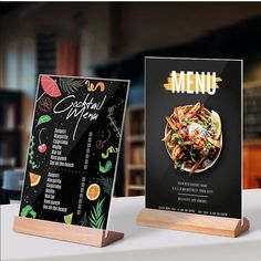 two restaurant menus sitting on top of a table