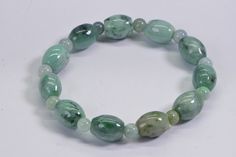 Genuine Burmese Jade Bracelet Light green to dark green smooth, shiny finished. beaded on stretch cord for more durable, I did double circle. Size bracelet 7.5 inch Jade barrel 12X8mm , round 5mm Your bracelet come in gift box. On picture exactly bracelet you will receive Green Oval Beads Bracelet As A Gift, Green Adjustable Beaded Bracelets With Oval Beads, Green Stretch Bracelet With Polished Round Beads, Green Stretch Bracelet With Polished Beads, Green Stretch Bracelet With Faceted Round Beads, Spiritual Green Stretch Bracelet With Polished Beads, Casual Green Stretch Bracelet With Large Beads, Green Jade Stretch Bracelet With Round Beads, Burmese Jade