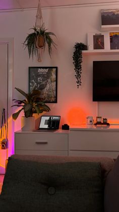 a living room filled with furniture and a flat screen tv mounted to the side of a wall