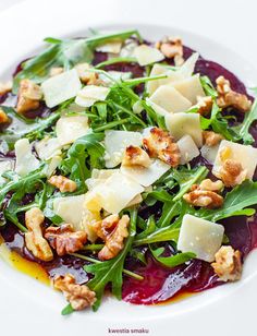 a white plate topped with salad and cheese