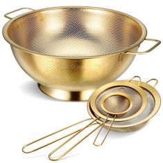 a golden colander and strainer set on a white background