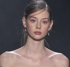 a woman in a strapless dress on the runway