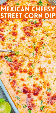 mexican cheesy street corn dip in a casserole dish with limes and cilantro