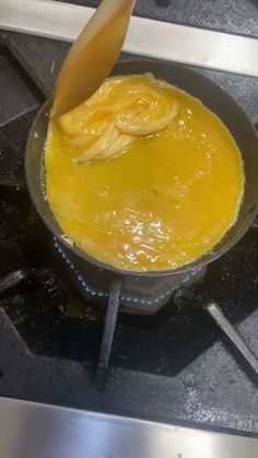 a pan filled with food cooking on top of a stove