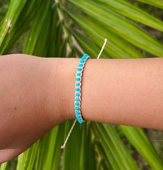 Our Kanapaha Bracelet is one of a kind featuring natural turquoise and an intricate design. This style is sure to stand out and embodies the bright blue waves. Natural turquoise stones Wax Cord approx 6" with adjustable 3.5" knot - adjustable and waterproof! Matching necklace and anklet!  Mix and match with your favorite HALT pieces or wear alone for boho beach vibes. The perfect gift for him or her. Our jewelry is handmade in the Sunshine State with local materials and shipped with an effort to use environmentally friendly packaging, making it the perfect choice for those who shop with a green mindset. Beach Jewelry Blue Hand-wrapped, Green Adjustable Cord Beach Bracelet, Turquoise Ocean-inspired Bracelets For Beach, Blue Multi-strand Wrap Bracelet For Beach, Adjustable Ocean-colored Bracelets For The Beach, Vacation Accessories, Natural Turquoise Stone, Perfect Gift For Him, Blue Waves