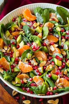 a salad with oranges, spinach and nuts