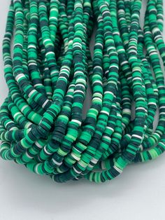 Cute green striped vinyl heishi beads. 300-400 beads per strand Size 6mm  Hole size 2mm  Length of strand 15-17" Cheap Green Necklace With Heishi Beads, Beads Polymer Clay, Vinyl Disc, Simple Bracelets, Types Of Gemstones, Beaded Top, Heishi Beads, Silver Bangle Bracelets, Polymer Clay Beads