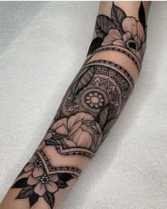 a woman's arm with flowers on it and a video play button in the middle