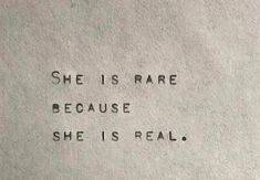 the words she is rare because she is real written on a piece of white paper