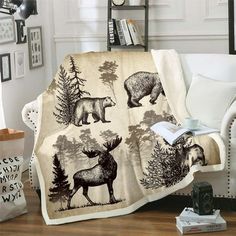 a living room with a white couch covered in a bear and moose print throw blanket