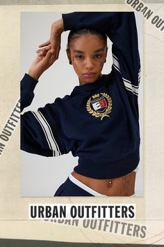 Classic chic Tommy Jeans by Tommy Hilfiger pullover in a slouchy, cropped fit. Features a crew neckline, drop shoulders and varsity stripes on the sleeves. Topped with embroidered Tommy Jeans, New York crest graphic at the chest for a preppy vibe. Features Tommy Jeans Crest boxy crewneck pullover Slouchy pullover sweatshirt Midweight knit with ribbed knit trim throughout Crew neckline and long sleeves with stripe details Embroidered Tommy Jeans, New York crest graphic at the chest Boxy, slouchy fit Cropped length Easy pull-over style Content + Care 100% Cotton Machine wash Imported Size + Fit Model in Navy is 5’9" and wearing size Small Measurements taken from size Small Chest: 42" Length: 20" | Tommy Jeans New York Crest Boxy Crewneck Pullover Top in Navy, Women's at Urban Outfitters Collegiate Crew Neck Tops With Logo Detail, Collegiate Graphic Print Crew Neck Top, Collegiate French Terry Sweatshirt, Sporty Crew-neck Top With Logo Patch, Tommy Hilfiger Crew Neck Sweatshirt For Streetwear, Classic Chic, Small Chest, Tommy Jeans, Pullover Sweatshirt