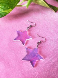 iridescent acrylic choice of sterling silver .925 or surgical stainless steel approximately 2" long in full length (from top of metal to bottom of acrylic), 1 1/8" wide made from an iridescent acrylic, these star earrings bring a groovy retro 1970s or 1980s vibe and lovely pastel rainbows this product is made to order, colors may appear slightly different care: the acrylic and metal can be cleaned with a light cleaner 2000s Earrings, Star Dangle Earrings, Iridescent Acrylic, Goth Earrings, Groovy Retro, Fun Jewelry, Earring Ideas, Indie Aesthetic, Earring Holder