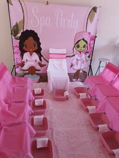 the table is set up for a spa party with pink boxes and towels on it