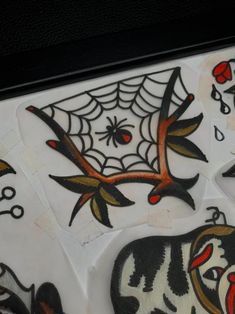 some stickers are on the back of a white board with black and red designs