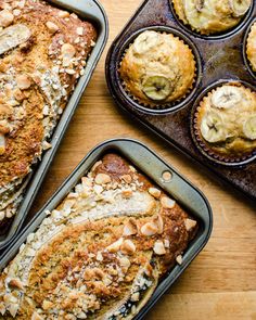 several muffins in pans on top of a wooden table