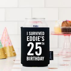 a can cooler with the number twenty five printed on it, next to cupcakes