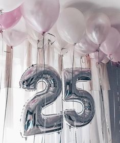 balloons and streamers are arranged in the shape of the number twenty five