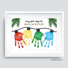 three colorful handprints hanging on a string with pine branches