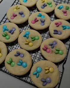 cookies decorated with candy and candies on a cooling rack