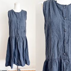 CURRENTLY OUT OF TOWN / THIS WILL SHIP AFTER OCTOBER 19TH. ENJOY 30% OFF - DISCOUNT ALREADY TAKEN!  Vintage faded black sleeveless shirt dress with chest pocket and drop waist. Era✦ 1980s Material✦ cotton and ramie  Closure✦ front buttons  Condition✦ all over wash fade, spots near pocket.  (cleaned & comes from a smoke-free home) ✂Measurements: Please do not go by its original tag size. Always go by the measurements listed below!!taken flat and doubled. Fits like women's S.  armhole: 16" around Black Sleeveless Shirt, Sleeveless Shirt Dress, Peplum Blouse, Dress Form, Sleeveless Shirt, Black Sleeveless, Drop Waist, Dress Clothes For Women, Grey Sweater