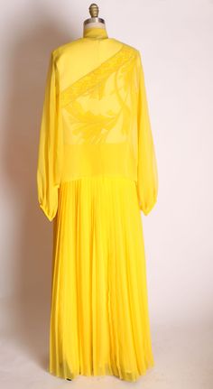 "1960's 1970's Yellow Polyester and Chiffon Accordion Pleated Full Length Sleeveless Dress with Matching Sheer Chiffon Jacket by Alfred Shaheen This dress features: *Vibrant yellow color *Floral/leaf detail on bodice *Chiffon skirt *Accordion pleated skirt *Sleeveless upper *Comes with matching sheer jacket *Bow tie on jacket neck Label: Alfred Shaheen Size: Large Measurements: Dress Measurements: Bust: 38\" Waist: 30\" Hip: Free Length: 59\" Jacket Measurements: Bust: 46\" Waist: Open Length: 2 Vintage Chiffon Day Dresses, Retro Sheer Dresses For Spring, Vintage Silk Chiffon Dress For Summer, Flowy Yellow Chiffon Dress, Vintage Sheer Chiffon Dress, Vintage Silk Chiffon Summer Dress, 1970s Style Silk Dresses For Spring, Luxury Yellow Chiffon Dress, Yellow Vintage Silk Dresses