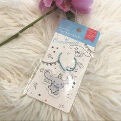 a package of stickers with an elephant and stars on it next to some pink flowers