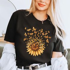 Sunflower Butterfly Shirt, Flower T-Shirt, Butterfly Tee, Floral Mothers Day Gift Tee, Mom Shirt, Womens Shirt, Trendy Shirts, Aesthetic Tee 👉HOW TO ORDER👈 1️⃣ Please review all the information provided before placing an order 2️⃣ Select the shirt type and size using the drop down menu. 3️⃣ Select the color of the shirt using the following drop down menu. 4️⃣ Need more Items? Add the current item in the cart. And If you like to add more items to your order please press the back button and repeat steps 1-3 again. 5️⃣ Once all your desired items are in your cart you may complete your order by entering your payment method, desired shipping address and click submit. 👉SIZING👈 If you are unsure about the size you should order, please refer to the size chart in the pictures. 👉PROCESSING TIME Yellow Printed T-shirt For Fall, Black T-shirt With Sunflower Print For Spring, Black Graphic Tee With Floral Print, Black Graphic Tee Shirt With Floral Print, Black Floral Print Graphic Tee Shirt, Spring Black T-shirt With Sunflower Print, Sunflower Print Crew Neck Graphic Tee, Sunflower Print Graphic Tee With Crew Neck, Casual Sunflower Design Crew Neck T-shirt