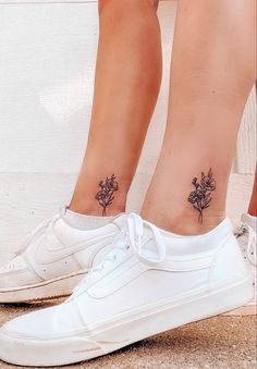 a woman's foot with a flower tattoo on her left ankle, and a white tennis shoe