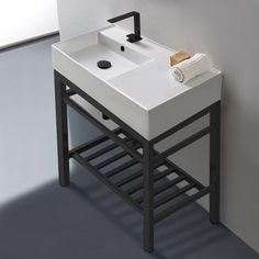 a white sink sitting under a mirror next to a wall mounted faucet in a bathroom