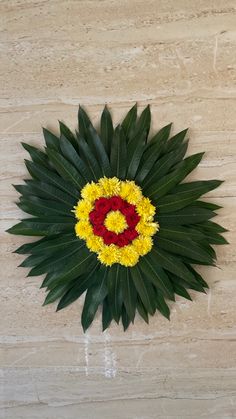 a circular arrangement of flowers arranged on a wall