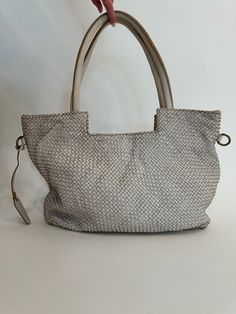 Elevate your bag collection with our Veronica Woven Tote Bag in Beige. This luxurious tote features an intricate braided design that showcases exceptional craftsmanship and timeless style. Made from high-quality materials, it combines durability with elegance, making it perfect for everyday use or special occasions. The spacious interior offers ample room for all your essentials, while the versatile beige color complements any outfit, adding a touch of sophistication to your look. Material: 100% Elegant Woven Leather Satchel Bag, Rectangular Shoulder Bag With Interwoven Design For Daily Use, Rectangular Bags With Interwoven Design For Daily Use, Elegant Bags With Woven Leather And Double Handle, Natural Rectangular Bags With Intrecciato Weave, Rectangular Interwoven Daily Bag, Rectangular Bag With Interwoven Design For Daily Use, Everyday Shoulder Bag With Interwoven Design, Everyday Interwoven Shoulder Bag