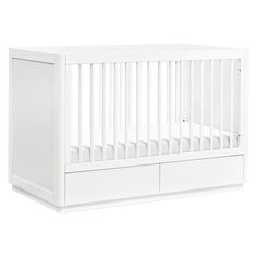 a white baby crib with two drawers