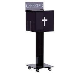 a black podium with a cross on it and the word offering written on top in white