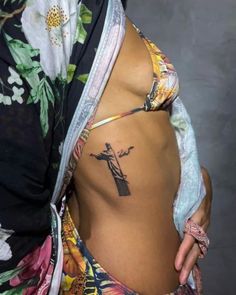 a woman with a cross tattoo on her stomach