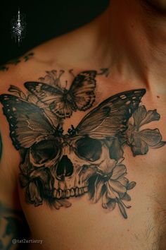 a skull and butterfly tattoo on the chest