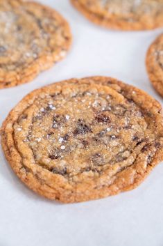 several chocolate chip cookies sitting on top of a baking sheet